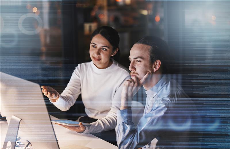 two people Infront of their computer